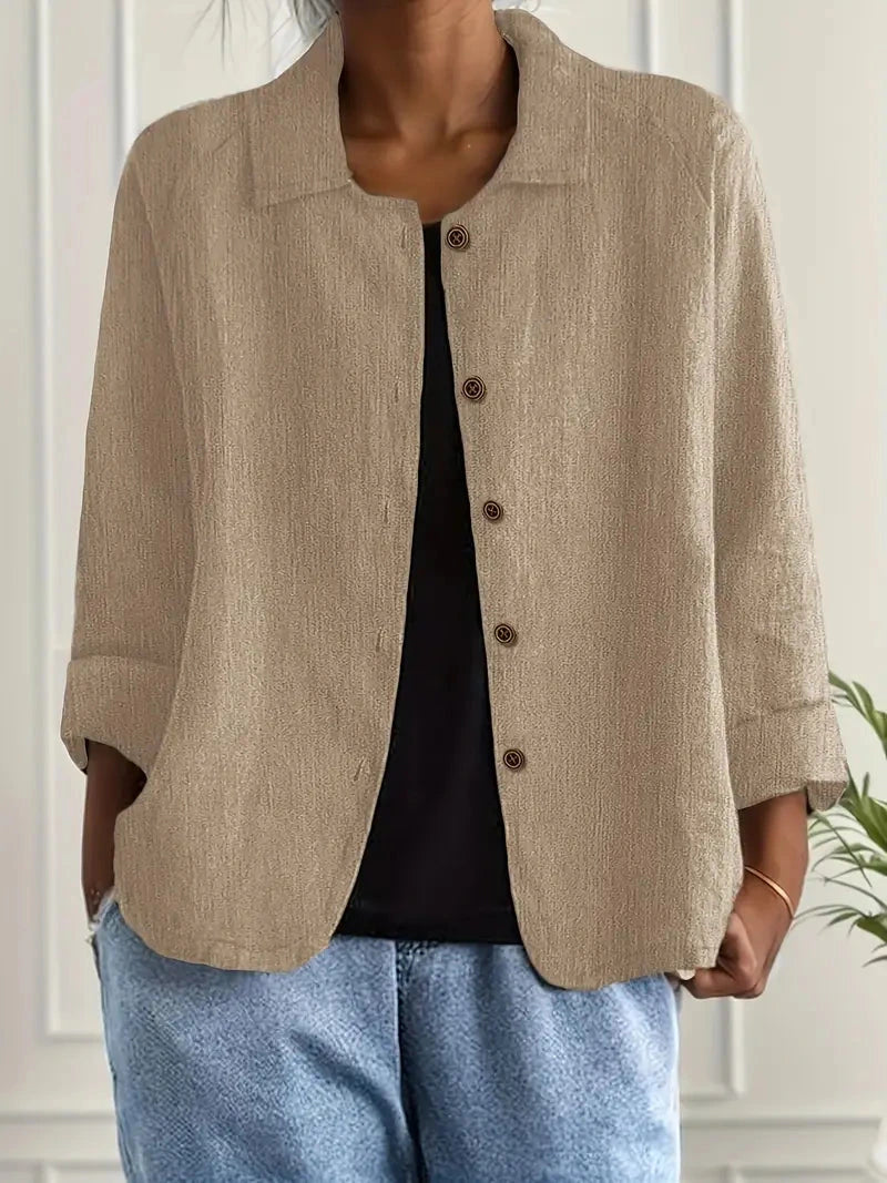 Woman wearing a khaki collared button-front long sleeve blazer in a studio setting