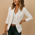 Woman wearing a white one-button fitted blazer in a studio setting