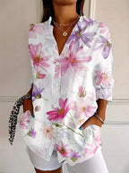 Woman wearing a white floral print button-down blouse in a lifestyle setting
