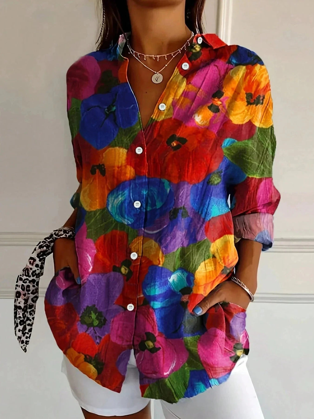 Woman wearing a mix 2 vibrant multicolor floral print button-down blouse, side profile view
