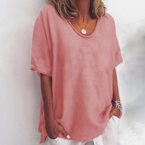 Woman wearing a dark pink v-neck short sleeve loose blouse in a studio setting