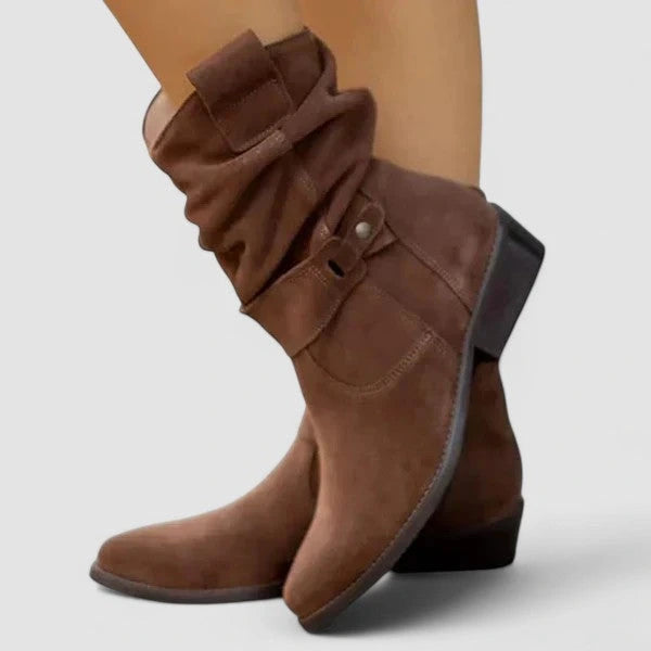 Woman wearing dark brown zipper ankle boots with arch support in an outdoor setting