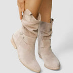 Woman wearing beige zipper ankle boots with arch support in a lifestyle setting
