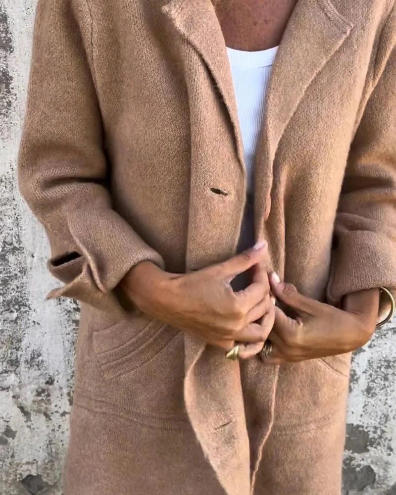 Woman wearing a khaki button-up long cardigan coat, close-up detail