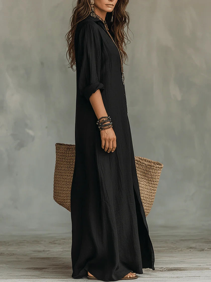 Woman wearing a black button-down maxi shirt dress, full-length front view in a studio setting
