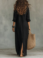 Woman wearing a black button-down maxi shirt dress, back view in a studio setting