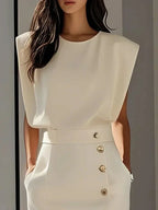 Woman wearing a beige button front sleeveless midi dress, close-up view