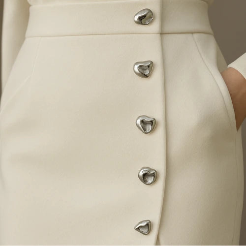 Close-up of a beige button front sleeveless midi dress showing the button detail