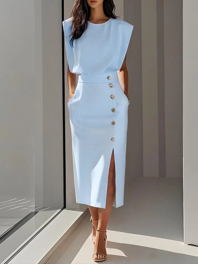 Woman wearing a light blue button front sleeveless midi dress in a studio setting