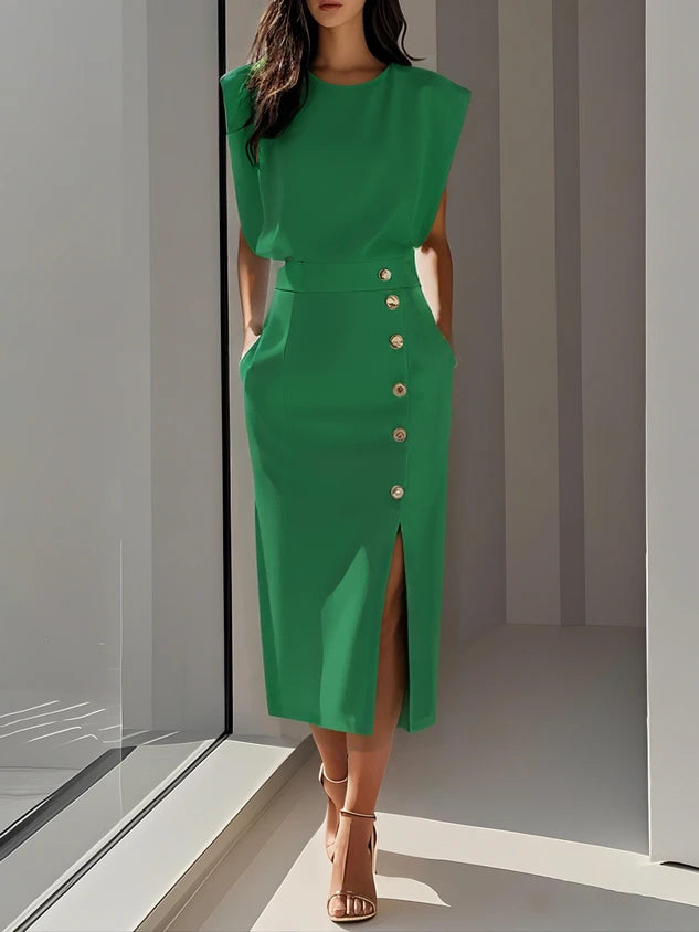 Woman wearing a green button front sleeveless midi dress in a studio setting
