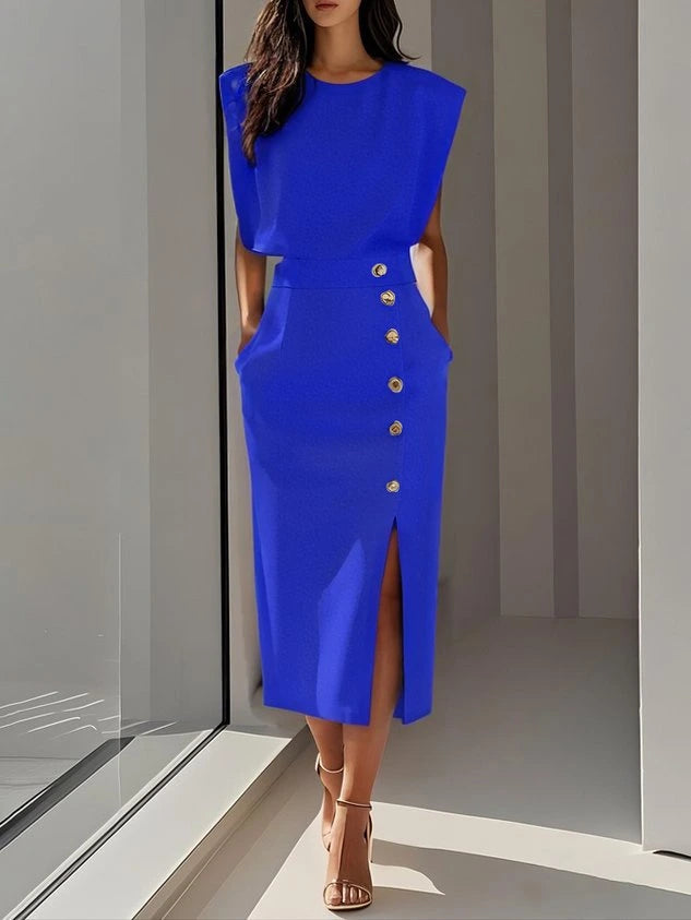 Woman wearing a royal blue button front sleeveless midi dress in a studio setting