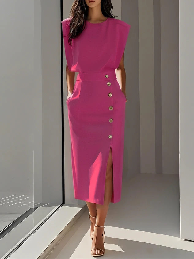 Woman wearing a bright pink button front sleeveless midi dress in a studio setting