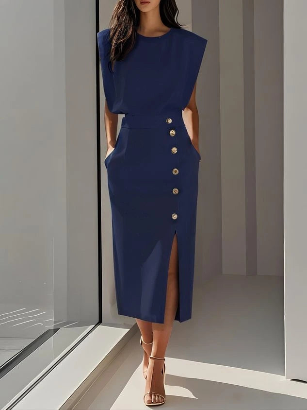 Woman wearing a blue button front sleeveless midi dress in a studio setting