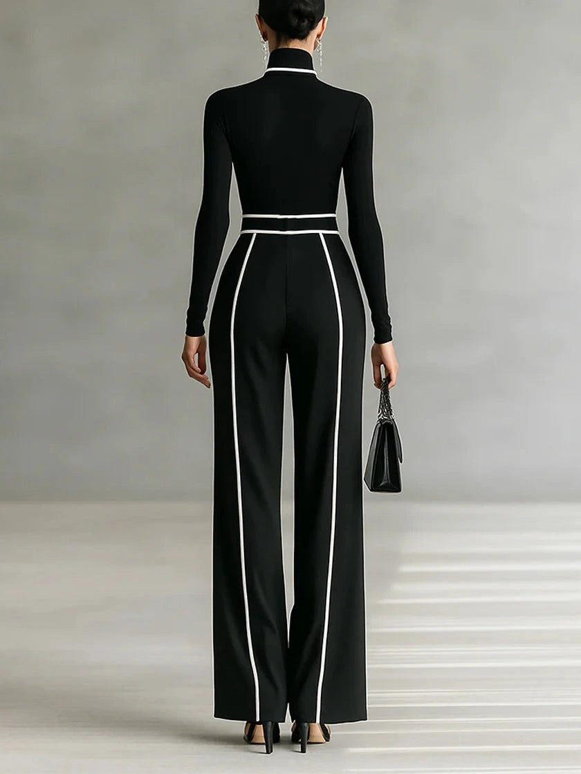 Woman wearing a black turtleneck and black wide-leg trousers with white contrast piping, back view