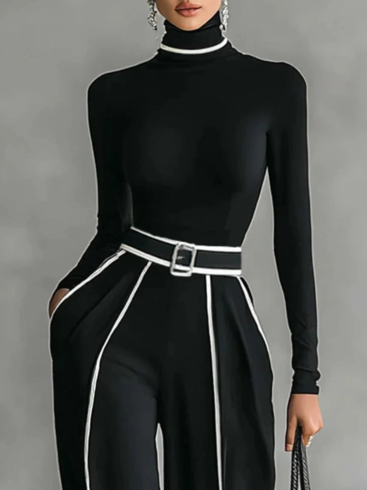 Close-up of black wide-leg trousers with white contrast piping and belt detail