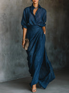 Woman wearing a dark blue elegant long-sleeve wrap maxi dress, front view