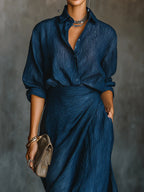 Woman wearing a dark blue elegant long-sleeve wrap maxi dress, close-up front view