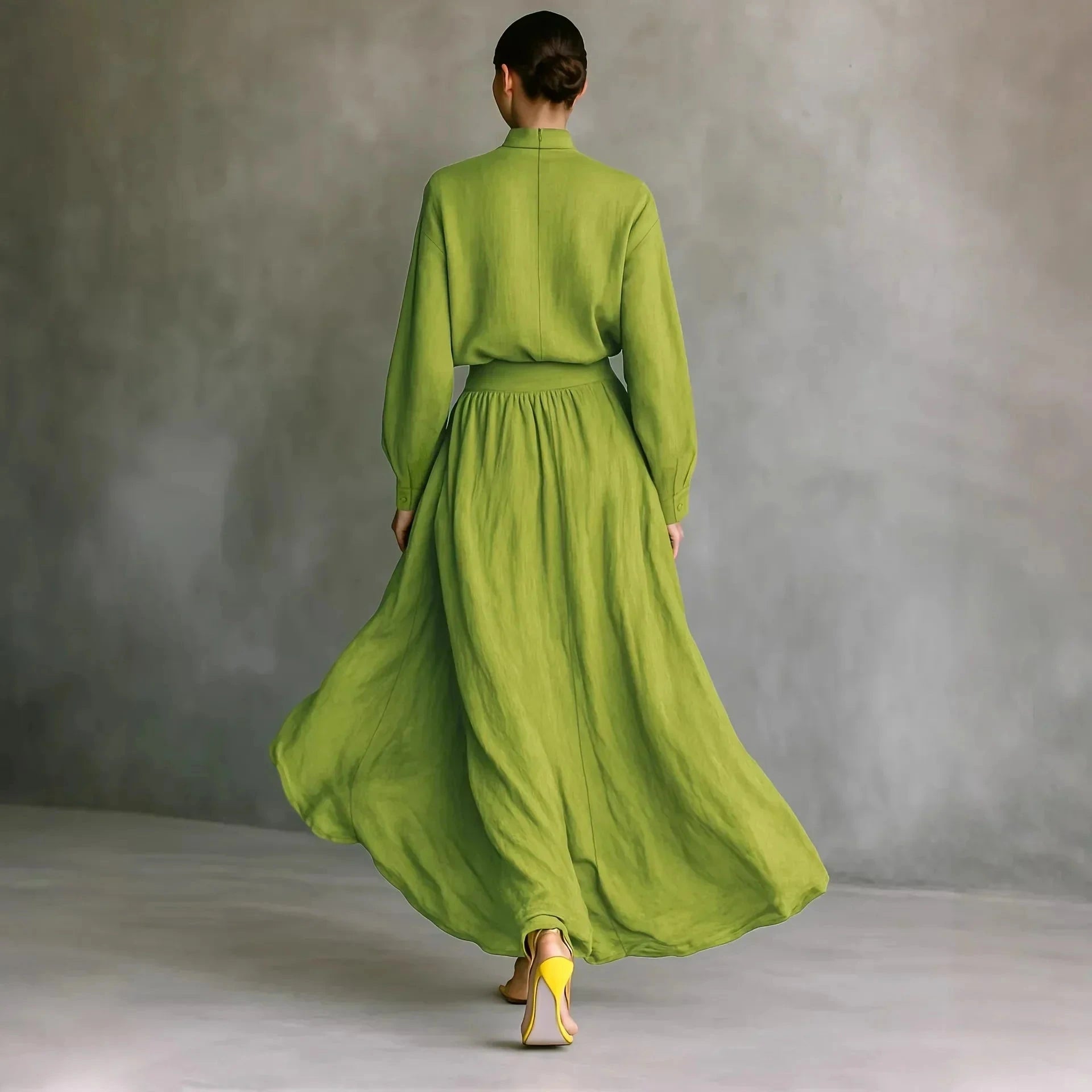 Woman wearing a yellow-green lightweight flowing midi dress, back view