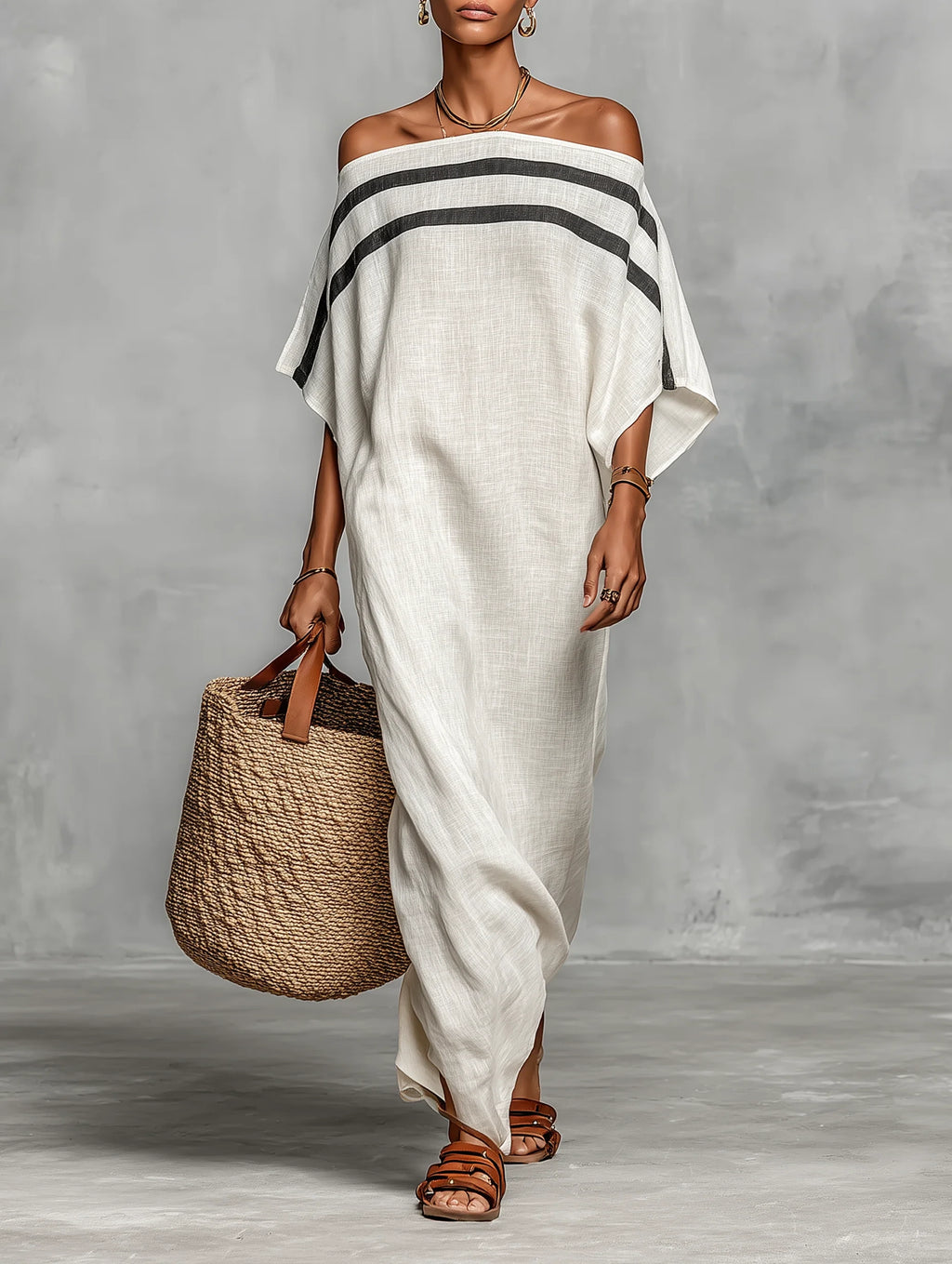 Woman wearing a white off-shoulder batwing maxi dress in a studio setting