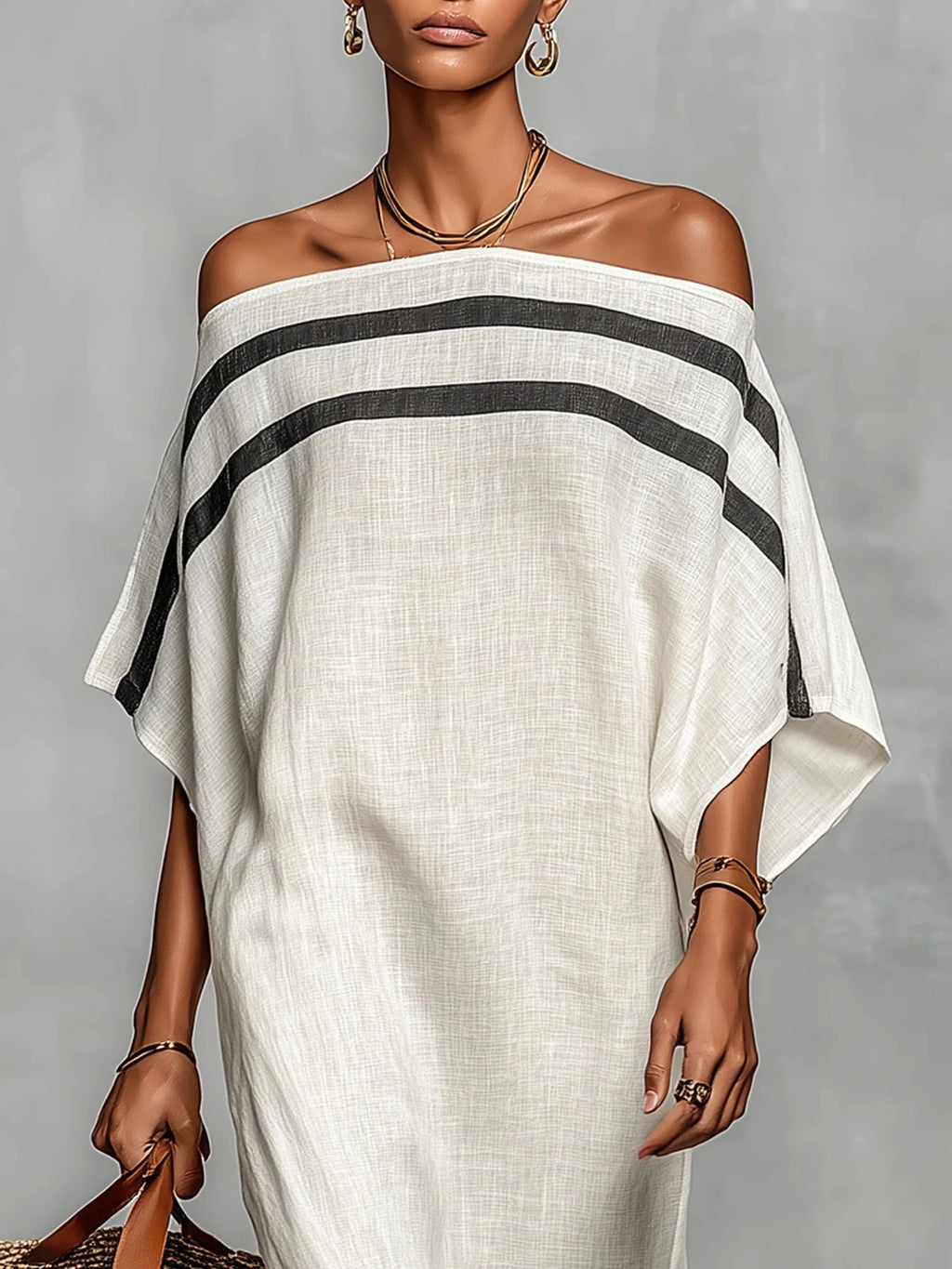 Woman wearing a white off-shoulder batwing maxi dress in a lifestyle setting
