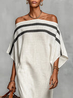 Woman wearing a white off-shoulder batwing maxi dress in a lifestyle setting