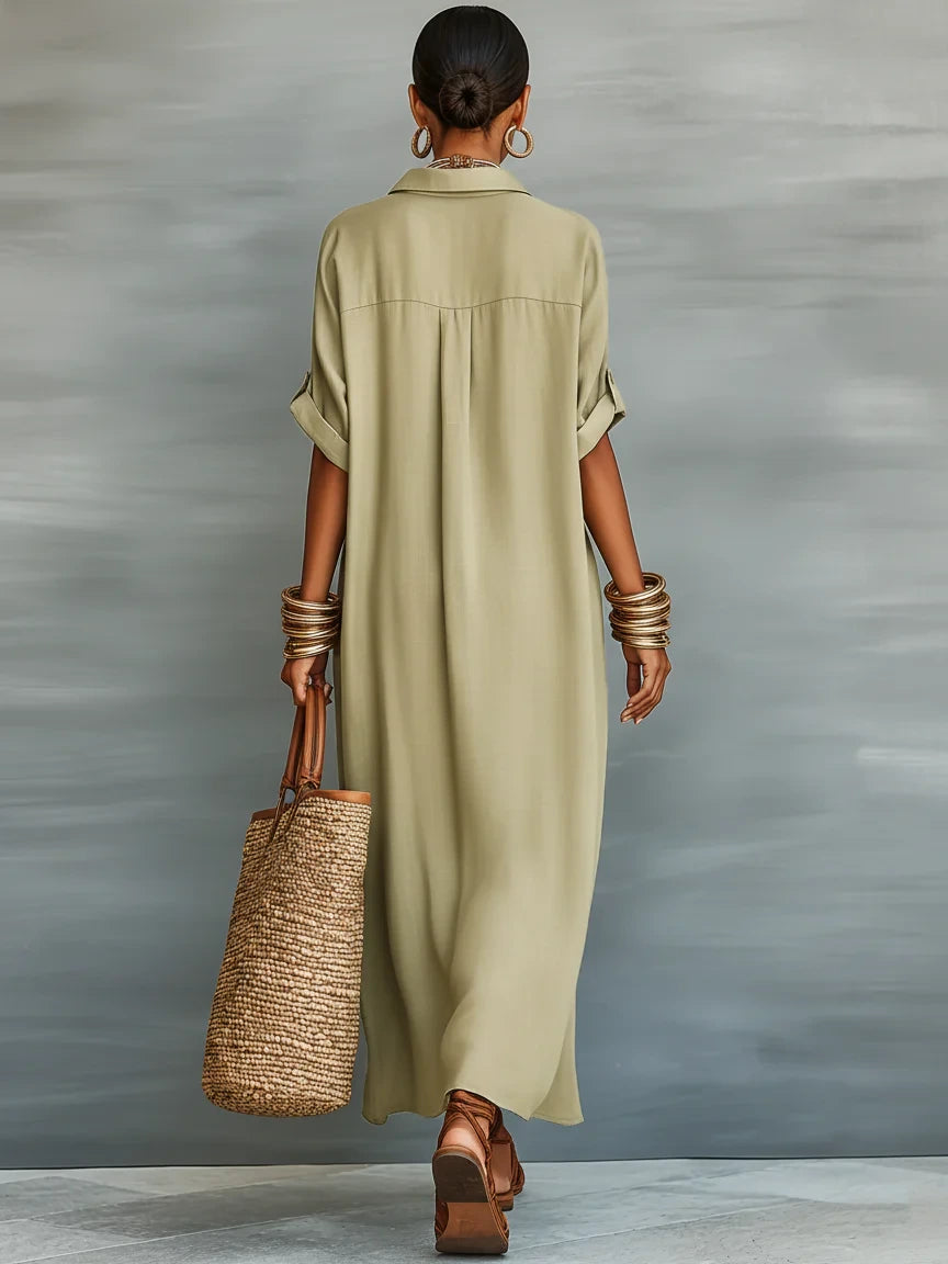 Woman wearing an olive green minimalist line maxi dress in an outdoor setting