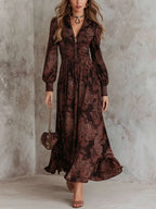 Woman wearing a brown paisley print long-sleeve fitted maxi dress, front view