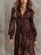 Woman wearing a brown paisley print long-sleeve fitted maxi dress, close-up front view