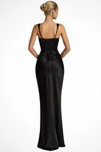 Woman wearing a black square neck ruched maxi dress, back view