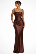Woman wearing a brown satin square neck ruched maxi dress