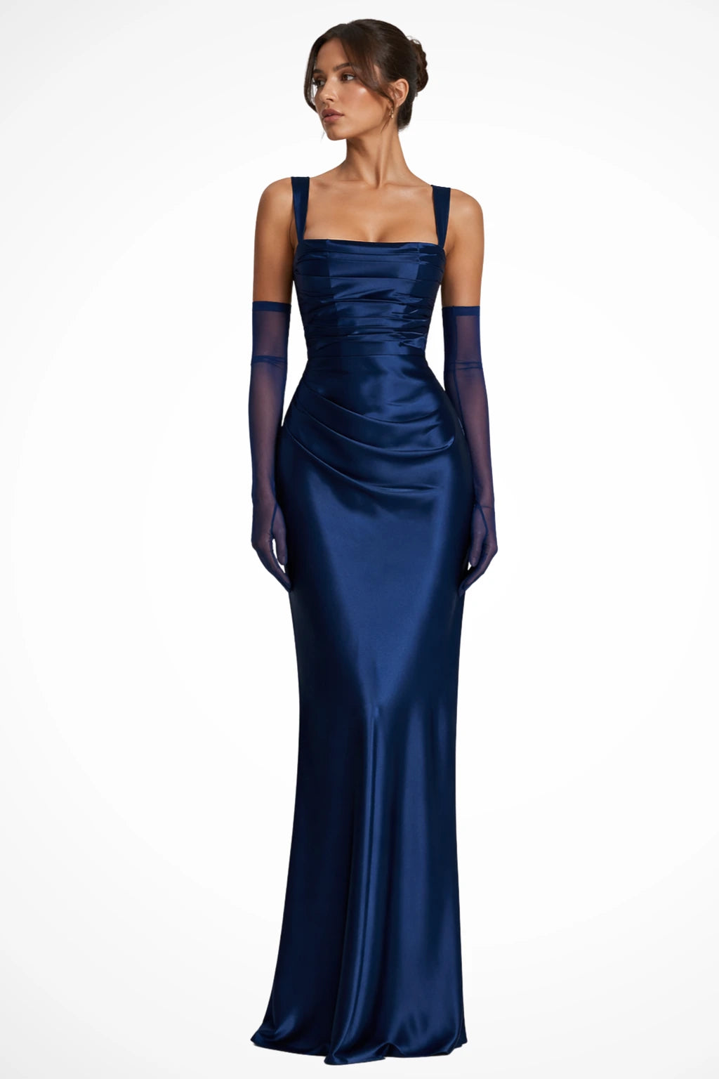 Woman wearing a navy blue satin square neck ruched maxi dress with sheer gloves