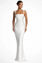 Woman wearing a white square neck ruched maxi dress