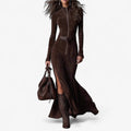 Woman wearing a brown zip-front long sleeve maxi dress in a studio setting