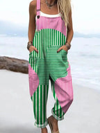 Woman wearing a pink and green abstract striped wide-leg jumpsuit, product catalog photo