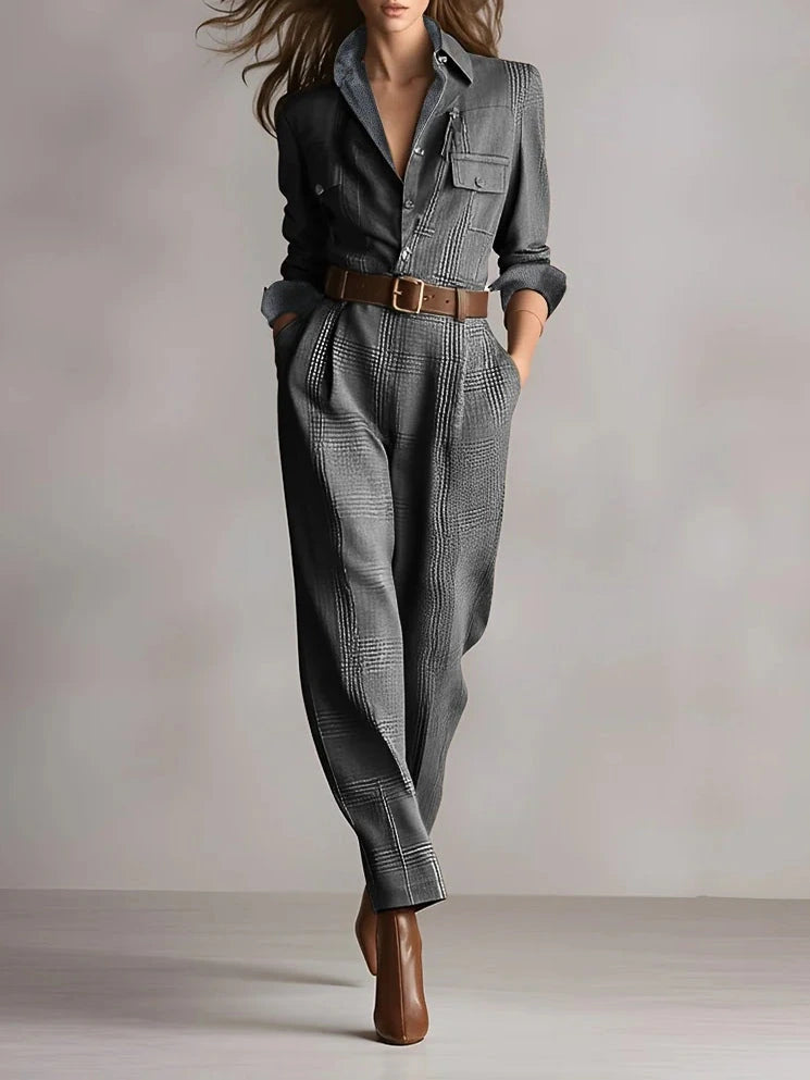 Woman wearing a gray checkered pattern jumpsuit with a belt, studio setting