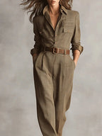 Close-up of a brown checkered pattern jumpsuit showing the belt and check print detail