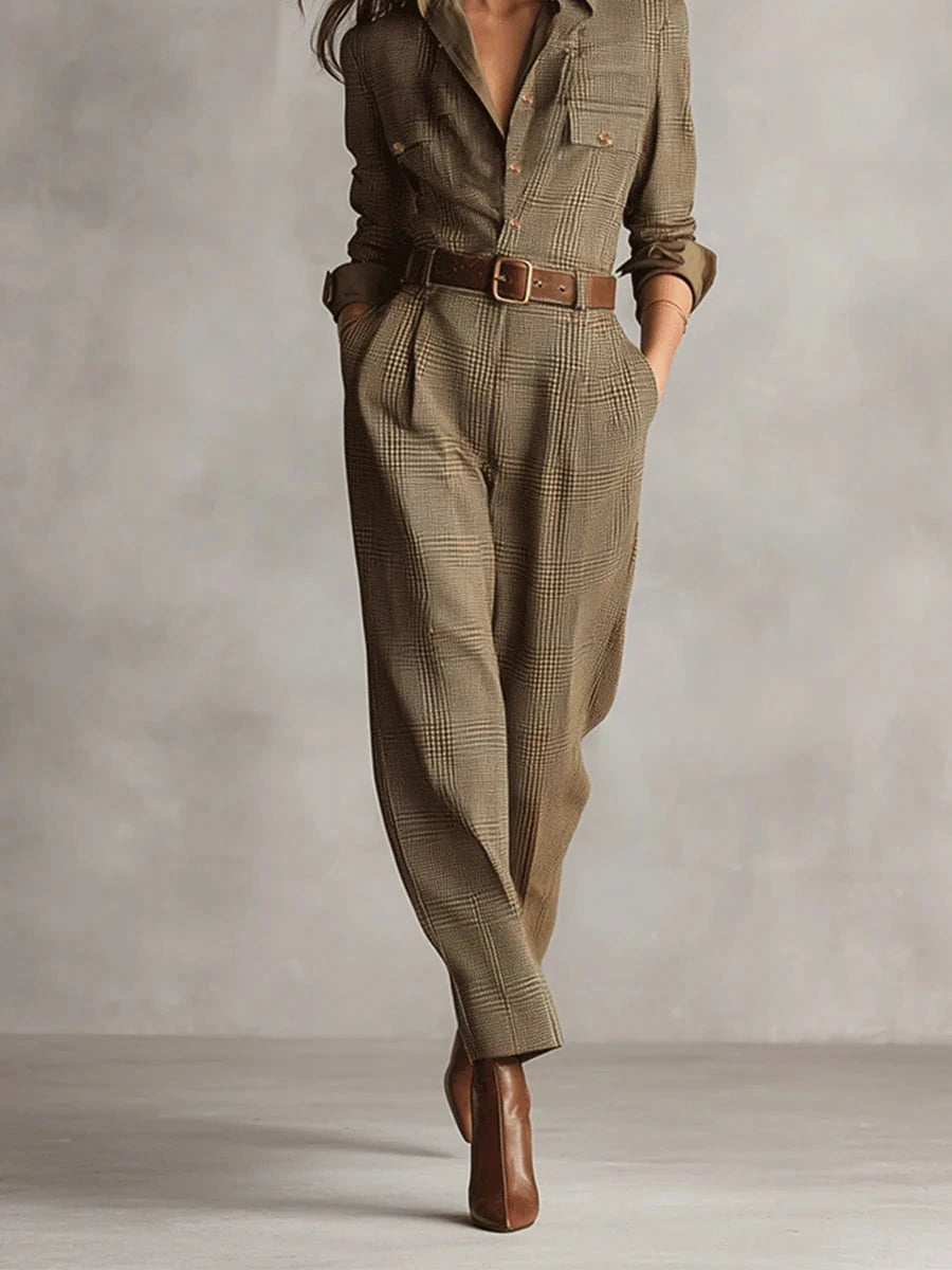 Woman wearing a brown checkered pattern jumpsuit, walking in a studio setting