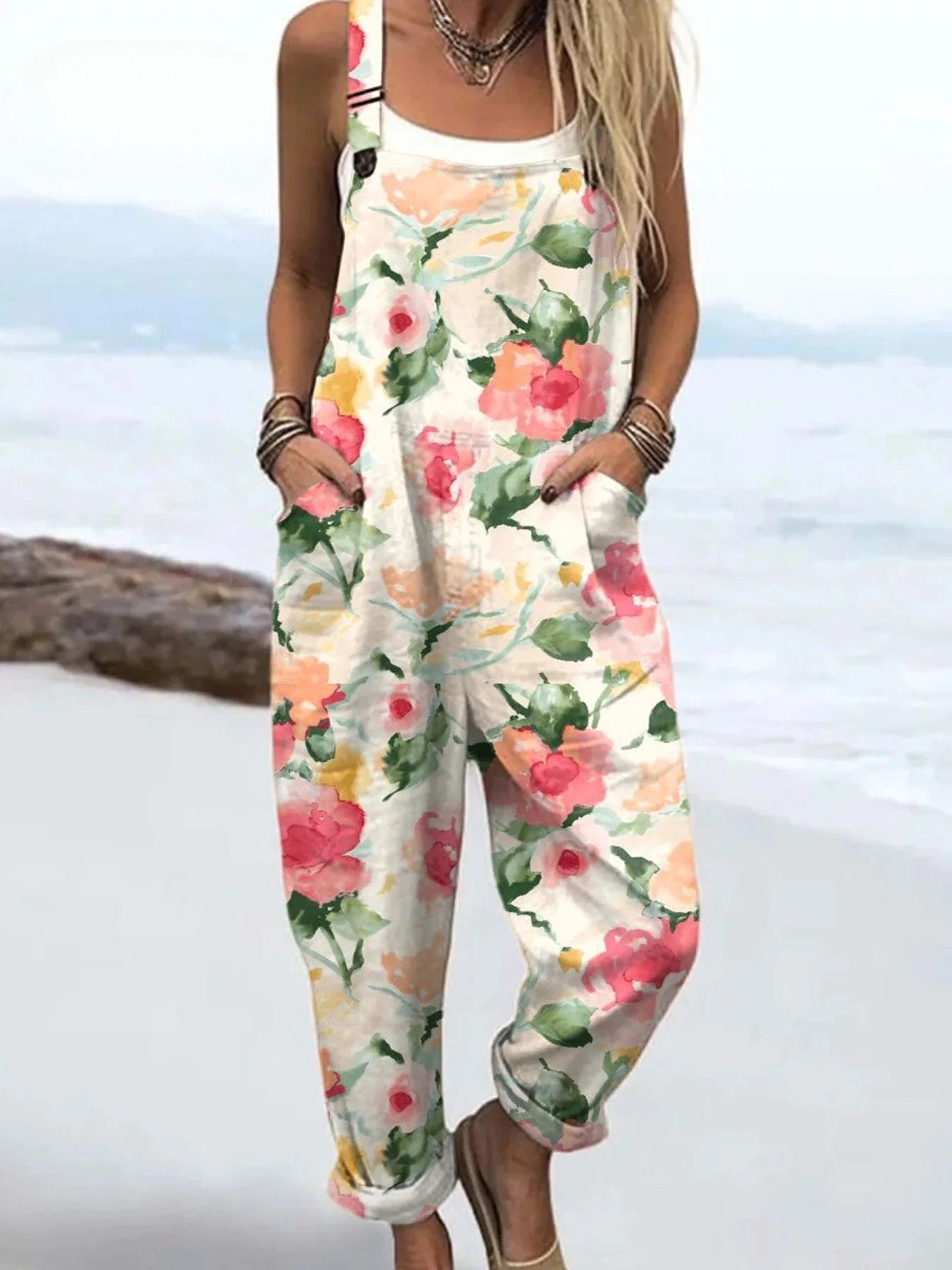 Woman wearing a white petal floral print jumpsuit, product catalog photo