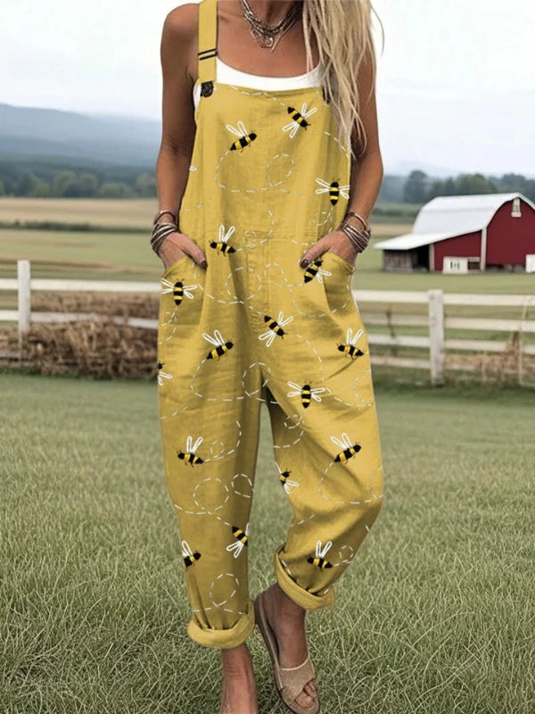 Woman wearing a mustard yellow honeybee floral print jumpsuit, product catalog photo