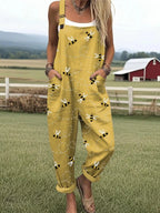 Woman wearing a mustard yellow honeybee floral print jumpsuit, product catalog photo
