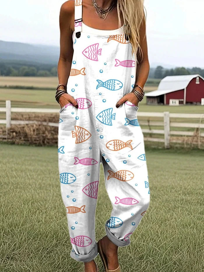 Woman wearing a white overall jumpsuit with a colorful fish print on a farm