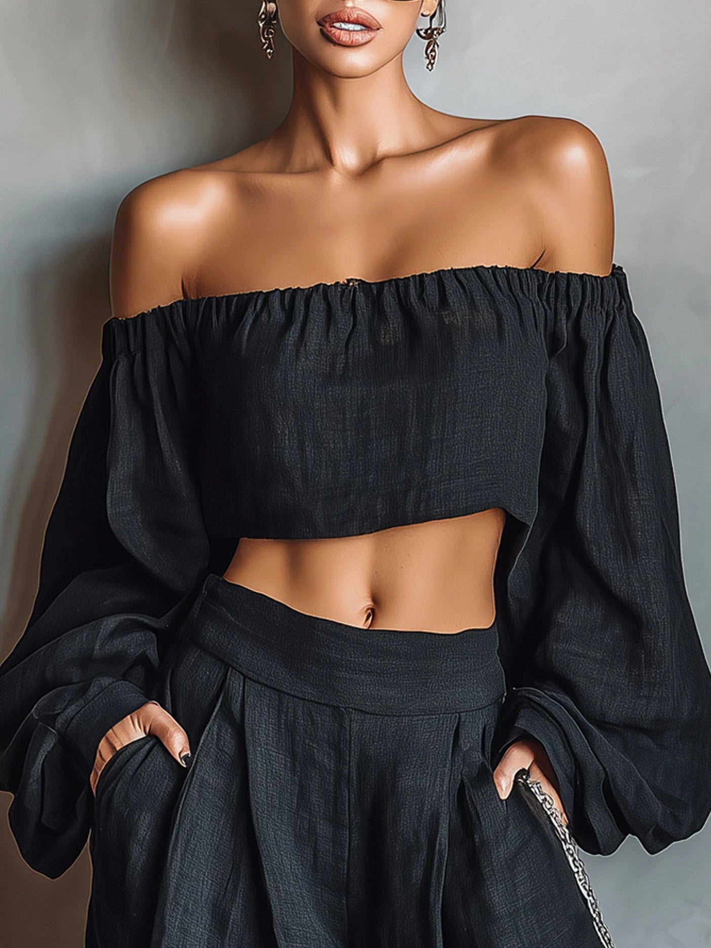 Woman wearing a black off-shoulder wide-leg jumpsuit in an outdoor setting
