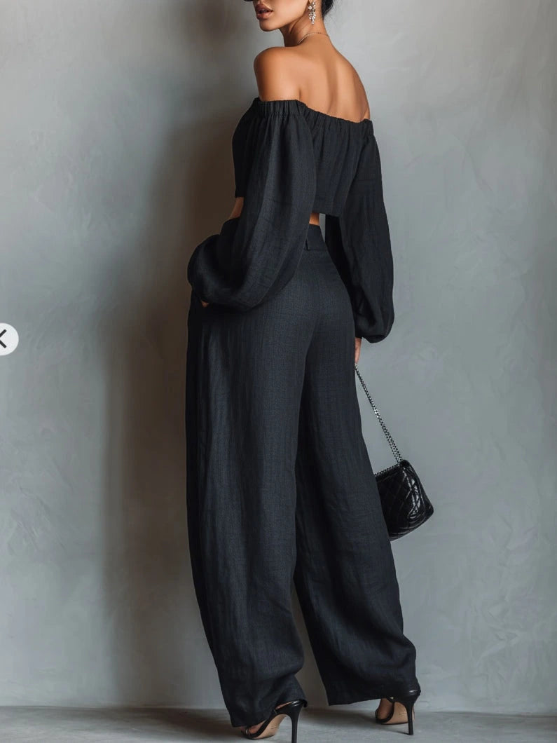 Close-up of a black off-shoulder wide-leg jumpsuit showing the neckline detail