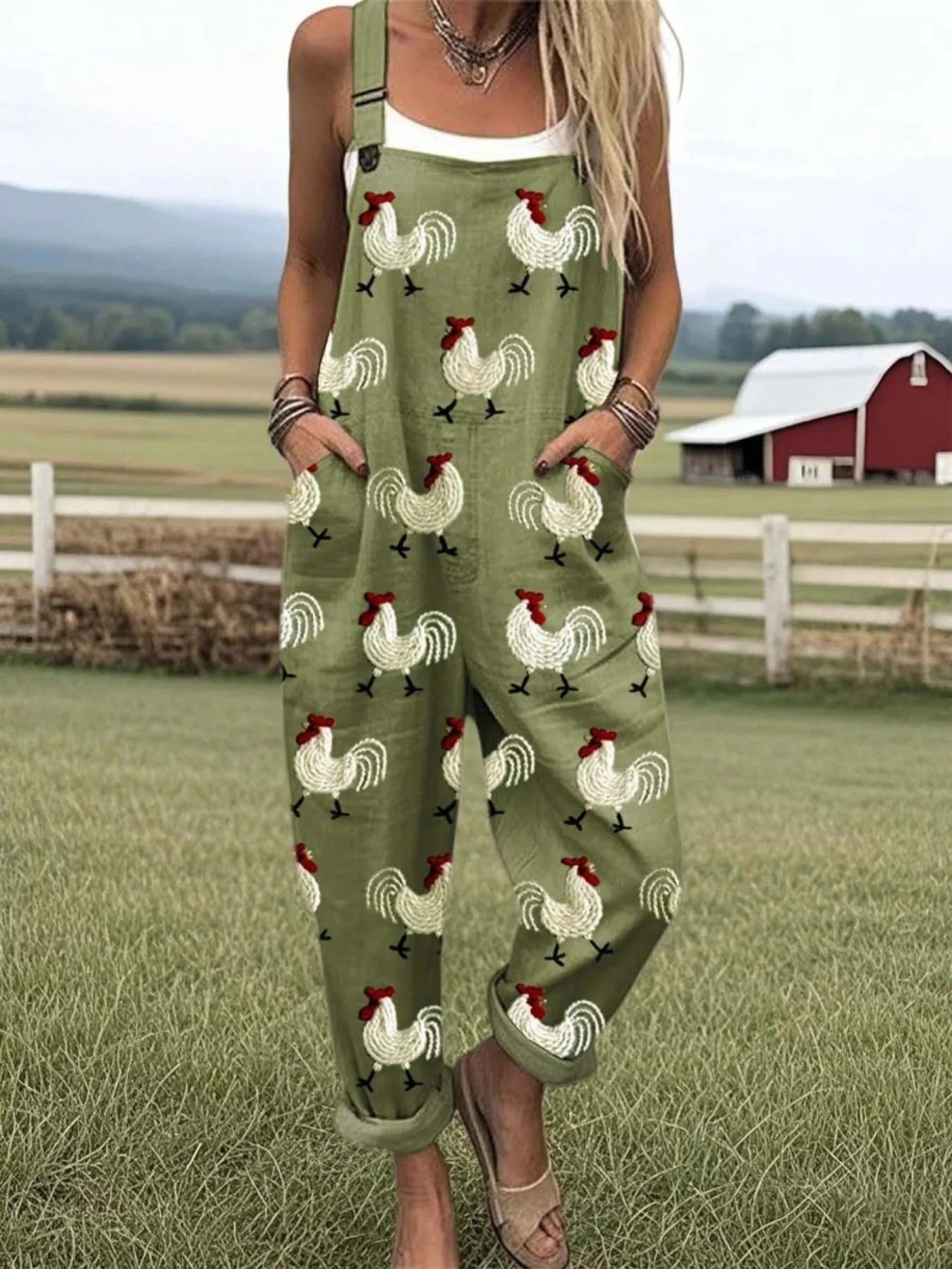 Woman wearing an olive green rooster print wide-leg jumpsuit, product catalog photo