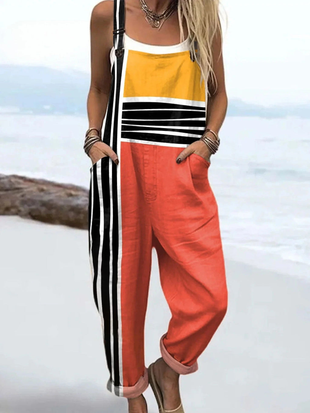 Woman wearing a striped color-block jumpsuit, product catalog photo