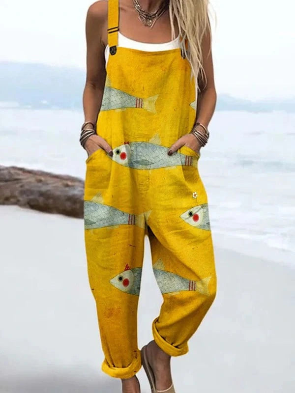 Woman wearing a mustard yellow fish print jumpsuit, product catalog photo