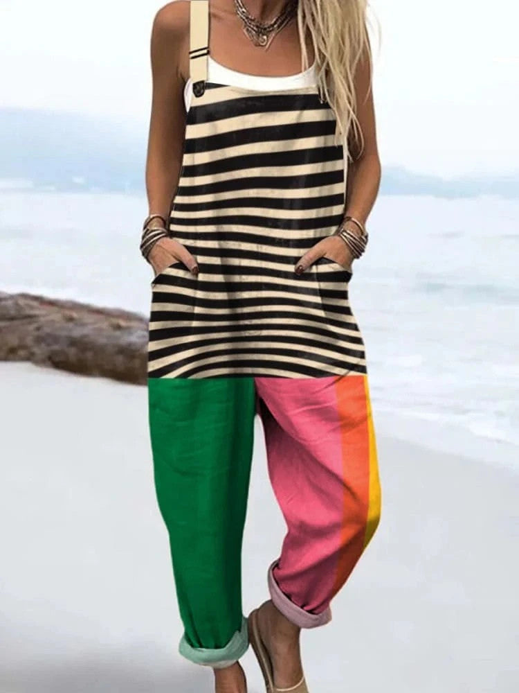 Woman wearing a striped and color-block jumpsuit standing on a sandy beach