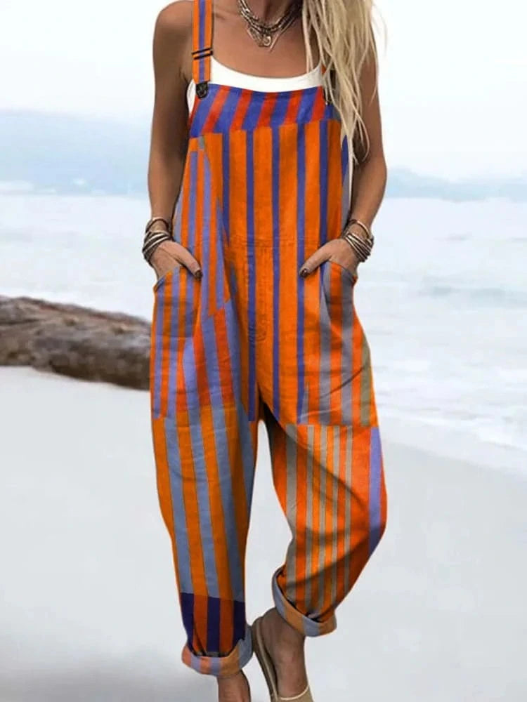 Woman wearing an orange and navy striped sunset print jumpsuit, product catalog photo