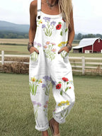 Woman wearing a white wildflower print jumpsuit, product catalog photo