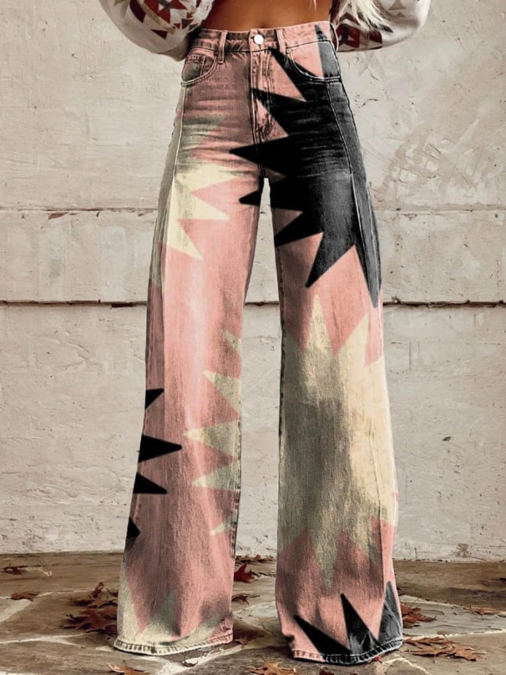 Close-up of pink bohemian chic high-waisted pants with a black star print, front view